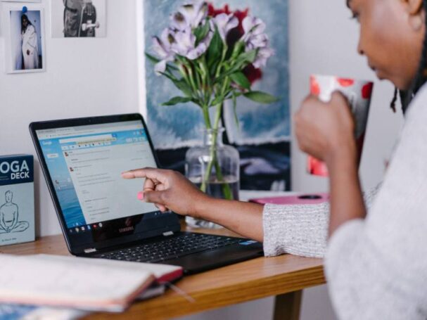 A Business Woman Pointing to Emails on Her Laptop