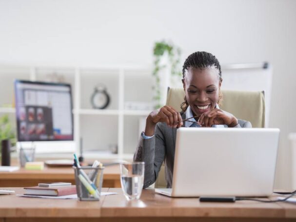 A Business Woman Smiling at a Laptop