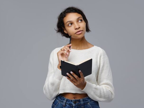 A Teen Holding a Book Researching