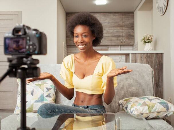 A Young Woman Filming Content on a Couch