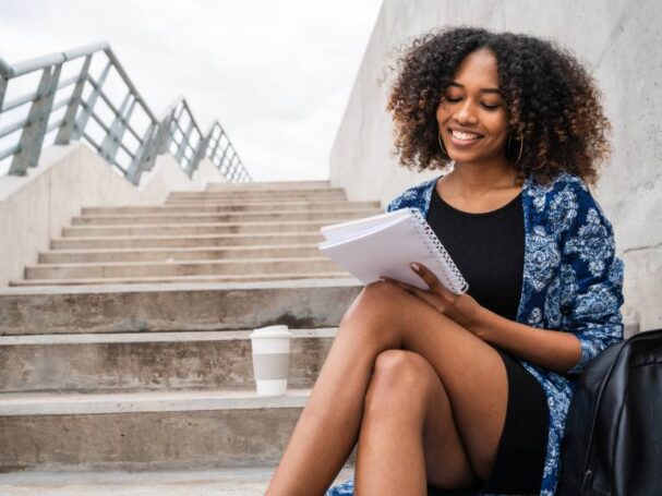 Afro American Woman Writing on Stairs