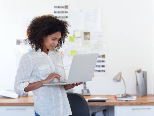 Black Afro Hair Female Entrepreneur Searching on a Laptop