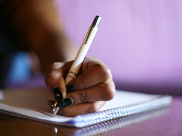 Close-Up on a Hand While Writing